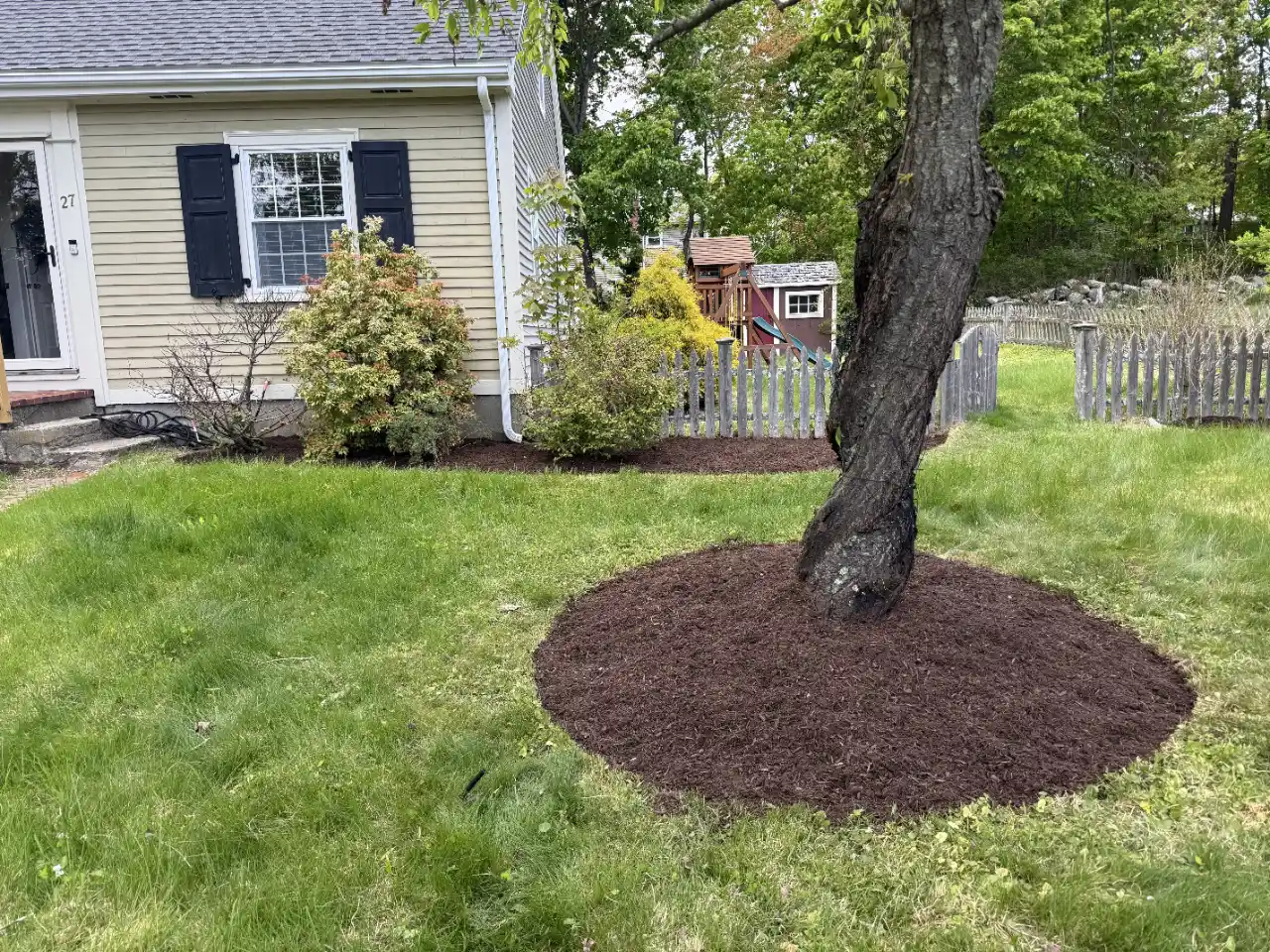 Gardener handling mulch and bark pieces